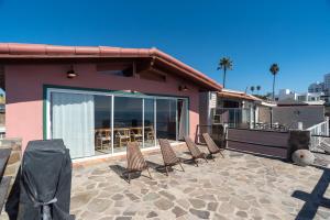 a group of chairs sitting on a patio at Rosarito Rosé in Las Gaviotas