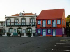 a colorful building on the side of a street at LOGEMENT REZ DE JARDIN A 4mn DES PLAGES in Case-Pilote