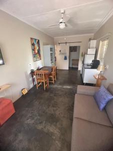 a living room with a couch and a table at Kremetart Villa in Alldays
