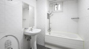a white bathroom with a sink and a bath tub at Jeonju COJAJA in Jeonju +51 photos