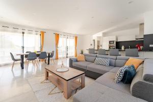 a living room with a couch and a table at L'Oasis de Saint-Quentin in Saint-Quentin-la-Poterie