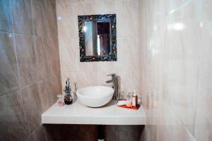 une salle de bain avec un lavabo et un miroir au mur dans l'établissement Nusa Dua Huts Pondok Gajah Para by EPS, à Nusa Dua 29 autres photos