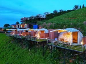 a row of luxury tents on the side of a hill at ภูชวนหลง ม่อนแจ่ม in Chiang Mai