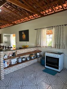 a kitchen with pots and pans on a counter at Chacara Antonio dos Reis (Piaui) in Mairinque