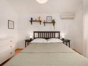 een slaapkamer met een groot bed en 2 tafels bij Five Bedroom Villa With Pool in Opanci +27 foto's