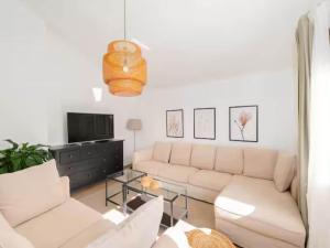 een woonkamer met een bank en een tv bij Five Bedroom Villa With Pool in Opanci