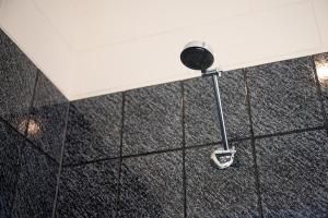 a shower with a shower head on the wall at Mildura Riverview Motel in Gol Gol +22 photos