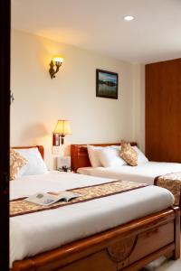 Postel nebo postele na pokoji v ubytování Khách Sạn Đồi Mây Đà Lạt + 8 fotografií