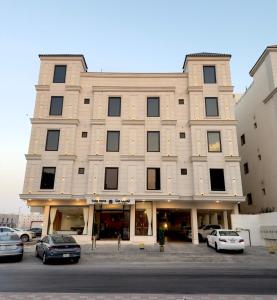 a large building with cars parked in front of it at توليب حتا Tulip Hatta in Al Khobar
