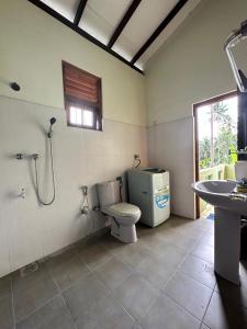 a bathroom with a shower and a toilet and a sink at Calm Casita Luxury Villa in Matara in Matara