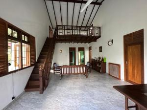 a living room with a staircase and a couch at Calm Casita Luxury Villa in Matara in Matara