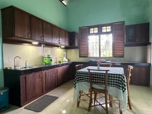 a kitchen with a table and a sink at Calm Casita Luxury Villa in Matara in Matara +26 photos
