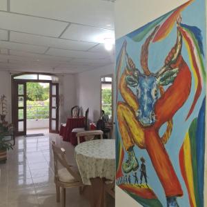 a painting of a deer on the wall of a room at Donde Mire in Puerto Colombia