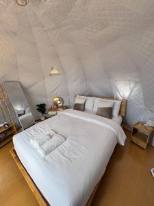 a bedroom with a large bed in a tent at เอวาเเคมป์ ภูชี้ฟ้า Avacamp phuchifa in Ban Seng Choi