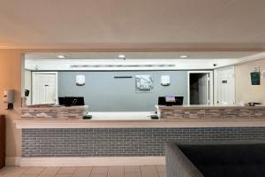 a lobby with a waiting room with a check in counter at Baymont by Wyndham Nacogdoches Near University in Nacogdoches