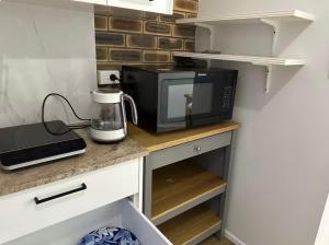 a microwave sitting on a counter in a kitchen at Mains Rd studio 带沙发阳光房 M8 in Brisbane