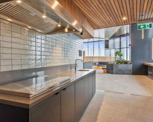 a kitchen with a sink and a counter top at Central Comfort CBD 2BR Apartment with Pool and Gym SKT1002 in Brisbane