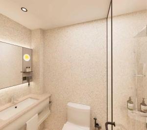 a bathroom with a shower and a toilet and a sink at A Hotel Farrer Park - Newly Renovated in Singapore