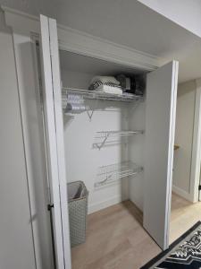 a walk in closet with shelves in a room at Cozy & Stylish 1BR Suite in Regina