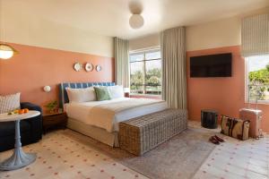 a hotel room with a bed and a television at Hotel Trouvail Miami Beach in Miami Beach +28 photos