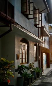 a building with potted plants on the side of it at IGN Residence Colombo in Colombo
