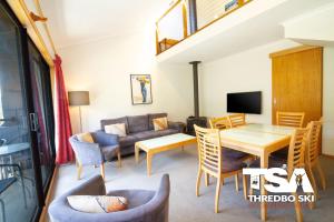 a living room with a couch and a table at Mowamba E6 in Thredbo