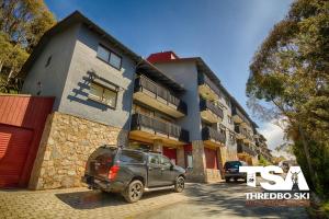 a car parked in front of a building at Mowamba E6 in Thredbo