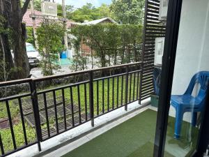 a balcony with a blue chair and a view of a street at Room in The Title Rawai Phase 1,2, Condo in Rawai, Room in Rawai, Room in The Title Rawai in Rawai Beach
