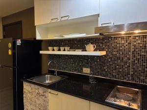 a kitchen with a sink and a refrigerator at Room in The Title Rawai Phase 1,2, Condo in Rawai, Room in Rawai, Room in The Title Rawai in Rawai Beach +6 photos