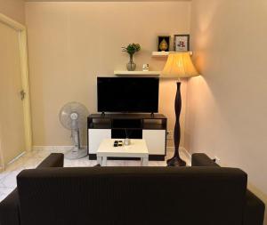 a living room with a couch and a tv at Room in The Title Rawai Phase 1,2, Condo in Rawai, Room in Rawai, Room in The Title Rawai in Rawai Beach