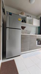 a kitchen with a white refrigerator in a room at The Azure Kathu in Kathu