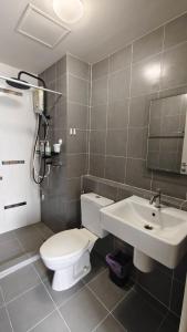 a bathroom with a toilet and a sink at The Azure Kathu in Kathu