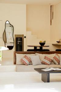 a living room with a couch and a table at Yugen Villas in Uluwatu