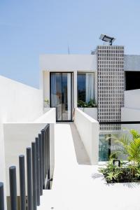 a view of a white building with a balcony at Yugen Villas in Uluwatu +23 photos