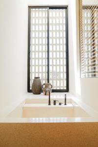 a sink in a room with a window at Yugen Villas in Uluwatu