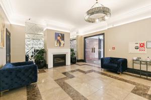 a living room with two chairs and a fireplace at Quest Wellington in Wellington