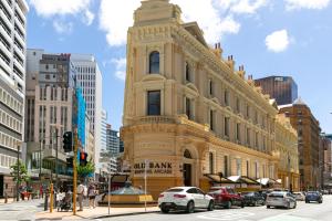 an old bank building on the corner of a city street at Quest Wellington in Wellington