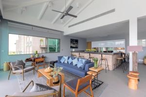 a living room with a blue couch and a bar at Tropical Castle Villa in Phuket