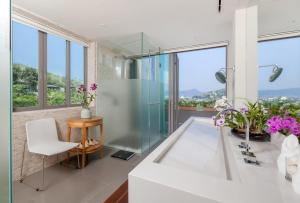 a bathroom with a glass shower and a white chair at Tropical Castle Villa in Phuket +32 photos