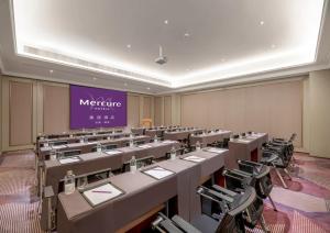 a large room with rows of tables and chairs at Mercure Lanzhou Dongfanghong Square Hotel in Lanzhou