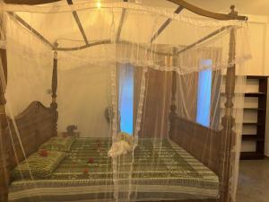 a bedroom with a bed with a canopy at Cinnamon Luxury Villa,Beruwala,Bentota in Beruwala
