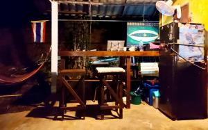 a wooden table and a refrigerator in a room at Mountain Jungalows, Koh Chang in Trat
