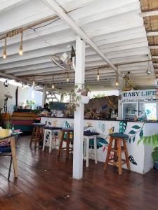 a restaurant with tables and chairs and a counter at Easy Life Koh Chang in Ko Chang