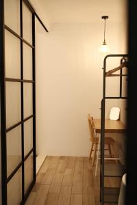 a dining room with a table and a ladder at 鄢室民宿 in Hualien City