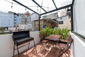 a balcony with a table and chairs and a piano at Whole House with 3 Bedrooms in Hoan Kiem - 7mins to Hoan Kiem lake - FREE launchdry & breakfast in Hanoi