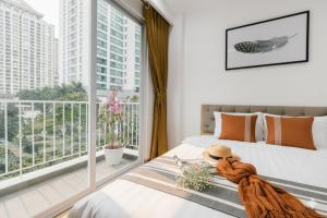 a bedroom with a bed and a large window at Label6 Studio West Lake in Hanoi