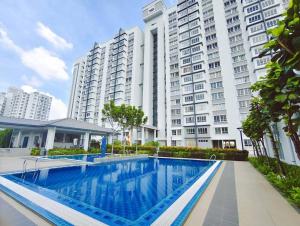 a swimming pool in front of a large building at The Duta Loft in Bandar Puncak Alam +8 photos