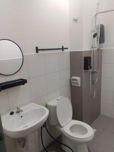a bathroom with a toilet and a sink at The Duta Loft in Bandar Puncak Alam