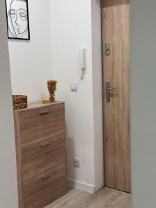 a room with a wooden dresser next to a door at Helenka Loft House 24H - Zabrze blisko A1, Arena Gliwice 15 min in Zabrze