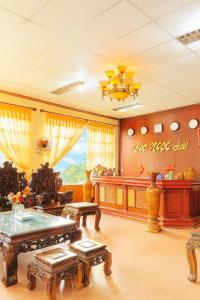 a living room filled with furniture and a table at Bảo Ngọc Hotel Quảng Trị in Lao Bao
